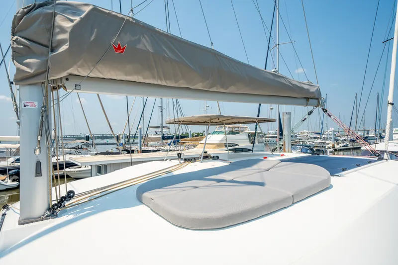 Slide: The Image of 2026 Lagoon 38 catamaran docked at marina under clear blue sky. - 15