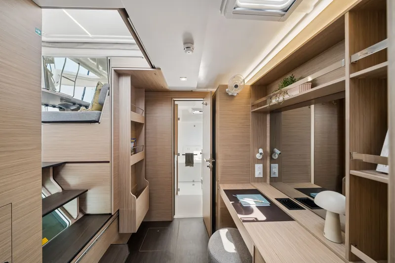 Slide: The Image of Luxurious interior of 2026 Lagoon 38 yacht featuring modern wood finishes and sleek design. - 64
