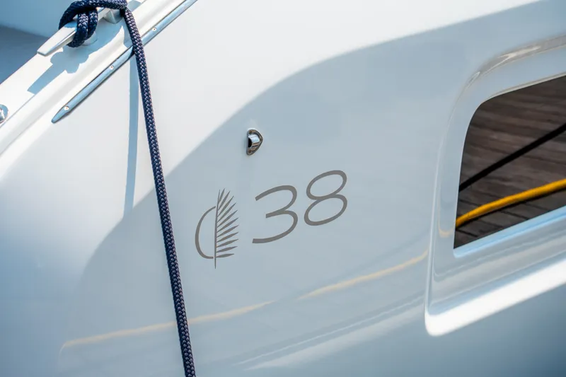 Slide: The Image of 2026 Lagoon 38 yacht exterior with logo and rope detail. - 30