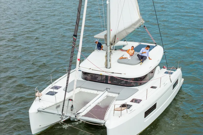 Slide: The Image of 2026 Lagoon 38 catamaran sailing with passengers relaxing on deck. - 6