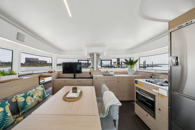 Slide: The Image of Modern interior of 2026 Lagoon 38 catamaran with kitchen, dining area, and panoramic windows. - 57