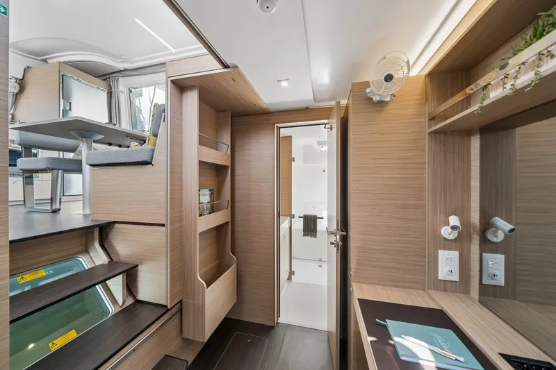 Slide: The Image of Modern interior of 2026 Lagoon 38 yacht, featuring sleek wood finishes and compact design. - 63