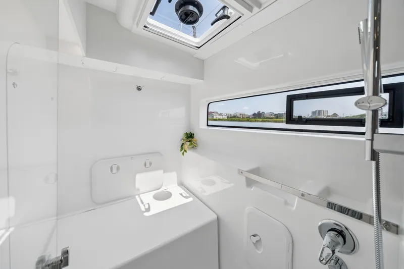 Slide: The Image of Modern bathroom interior of 2026 Lagoon 38 yacht with sleek design and window view. - 69