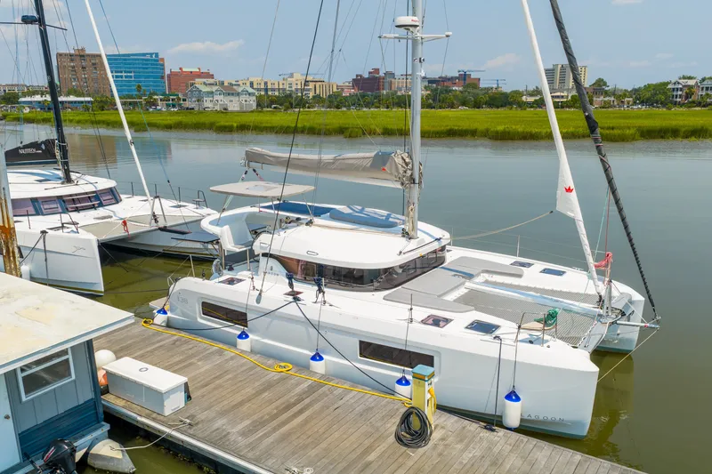 Slide: The Image of 2026 Lagoon 38 catamaran docked at marina, surrounded by calm water and cityscape. - 81