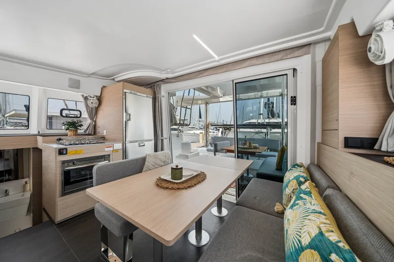 Slide: The Image of Modern interior of 2026 Lagoon 38 catamaran with dining area and kitchen. - 62