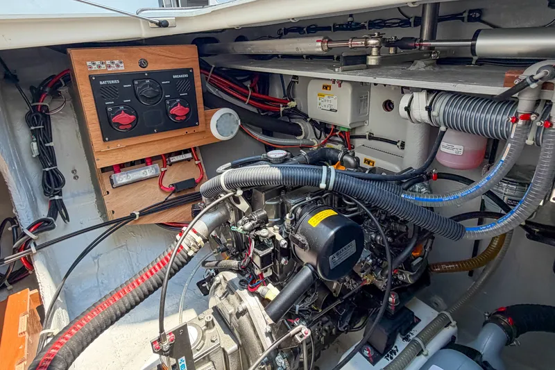 Slide: The Image of Engine compartment of a 2026 Lagoon 38 catamaran, showcasing wiring and control panel. - 121