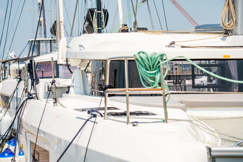 Slide: The Image of 2026 Lagoon 38 catamaran docked, showcasing sleek design and modern features. - 26