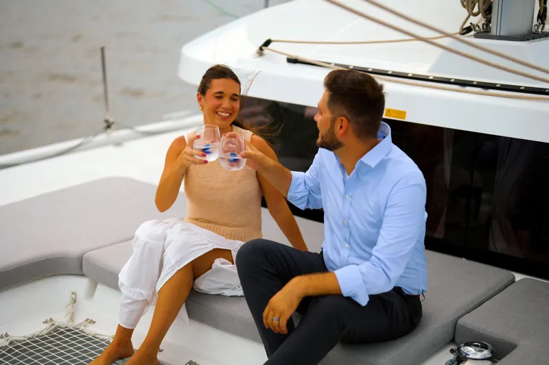 Slide: The Image of Couple enjoying drinks on a 2026 Lagoon 38 catamaran deck. - 131