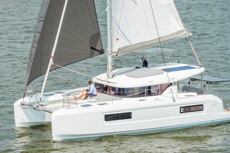 Slide: The Image of 2026 Lagoon 38 catamaran sailing on open water, featuring sleek design and modern sails. - 1