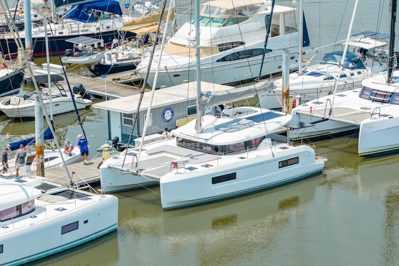 Slide: The Image of Marina with 2026 Lagoon 38 catamaran docked among various boats. - 88
