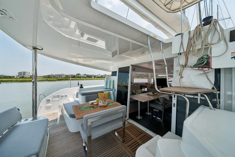 Slide: The Image of Luxurious 2026 Lagoon 38 catamaran with spacious deck and elegant interior dining area. - 38