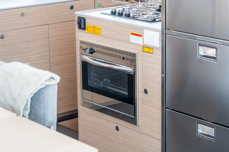 Slide: The Image of Modern kitchen interior on Lagoon 38 yacht, featuring a sleek oven and stove, 2026 model. - 58