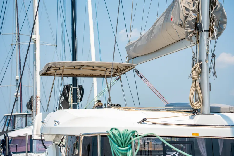 Slide: The Image of 2026 Lagoon 38 catamaran with sails and rigging in a marina setting. - 27