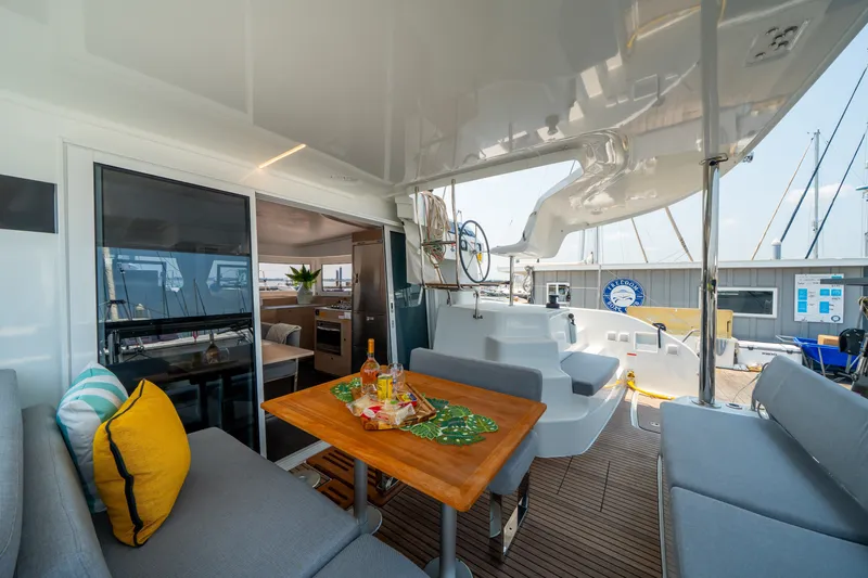 Slide: The Image of Modern Lagoon 38 catamaran interior, featuring a cozy seating area and dining table, 2026 model. - 41