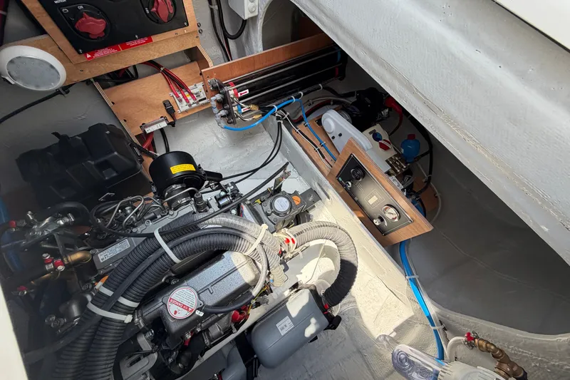 Slide: The Image of Engine compartment of a 2026 Lagoon 38 boat, showcasing mechanical components and wiring. - 118