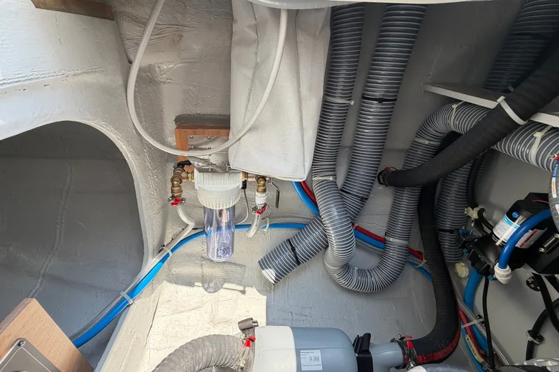 Slide: The Image of Interior view of 2026 Lagoon 38 yacht's plumbing and filtration system. - 117