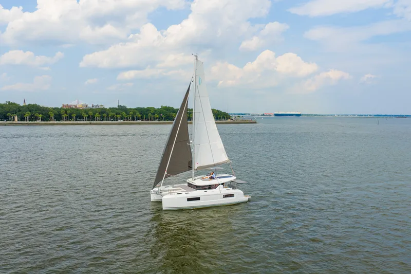 Slide: The Image of Sailing catamaran Lagoon 38, 2026 model, cruising on a calm sea under a cloudy sky. - 94