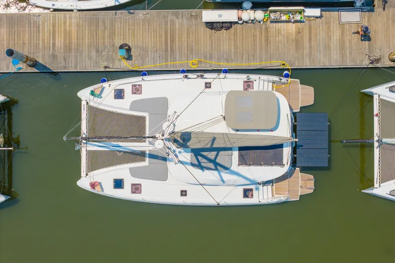 Slide: The Image of Aerial view of 2026 Lagoon 38 catamaran docked at marina. - 90