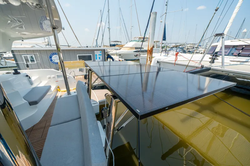 Slide: The Image of Modern Lagoon 38 catamaran with solar panels, docked at a marina, 2026 model. - 18