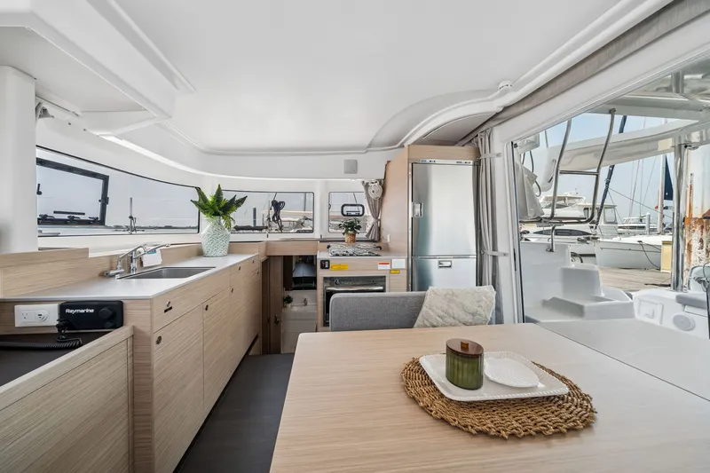 Slide: The Image of Modern interior of 2026 Lagoon 38 catamaran with sleek kitchen and dining area. - 61