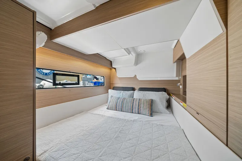 Slide: The Image of Luxurious cabin interior of 2026 Lagoon 38 yacht with modern bedding and wood accents. - 74