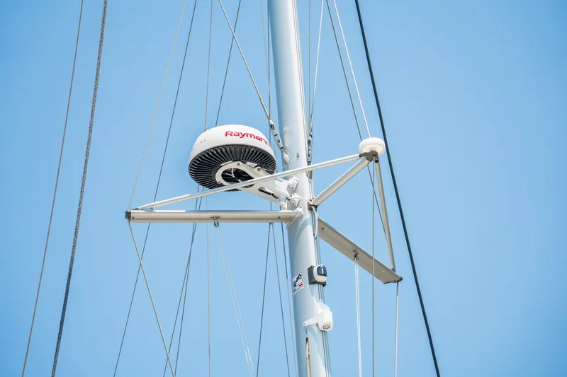 Slide: The Image of Radar equipment on a 2026 Lagoon 38 sailboat mast against a clear blue sky. - 24