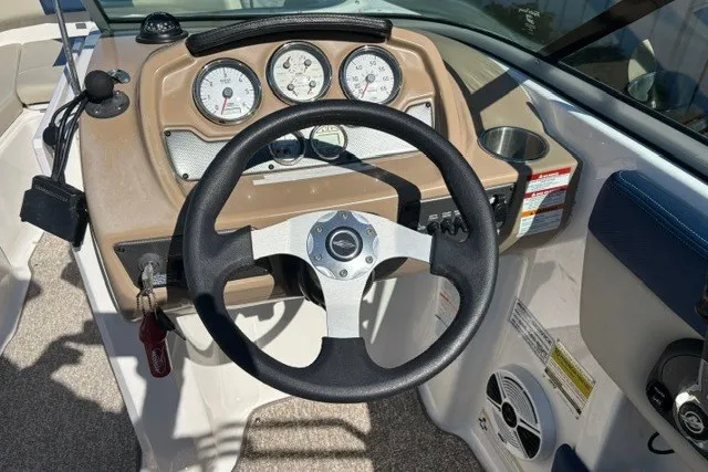 Slide: The Image of 2015 Chaparral 21 SSi Ski & Fish boat dashboard with steering wheel and gauges. - 9