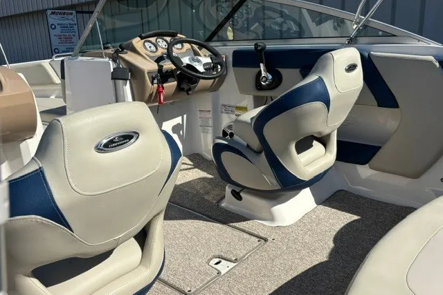 Slide: The Image of 2015 Chaparral 21 SSi Ski & Fish boat interior with beige and blue seating. - 19