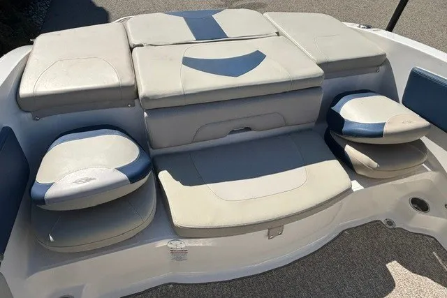Slide: The Image of 2015 Chaparral 21 SSi Ski & Fish boat seating area with cushioned seats and storage compartments. - 18