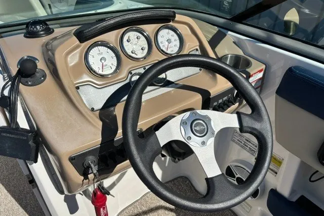Slide: The Image of 2015 Chaparral 21 SSi Ski & Fish boat dashboard with steering wheel and gauges. - 8