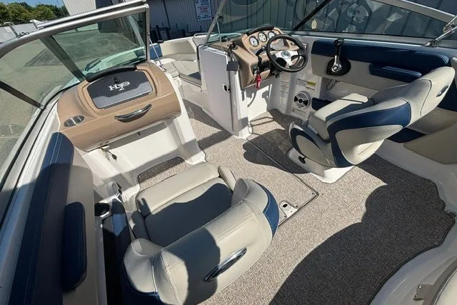 Slide: The Image of 2015 Chaparral 21 SSi Ski & Fish boat interior with seating and dashboard. - 21
