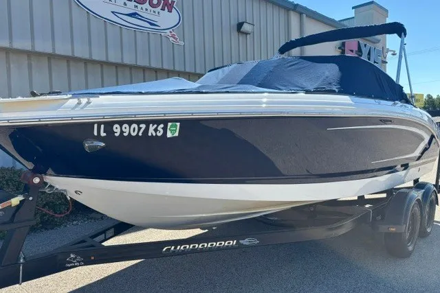 Slide: The Image of 2015 Chaparral 21 SSi Ski & Fish boat on trailer, covered and parked outside a building. - 28