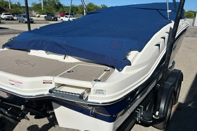 Slide: The Image of 2015 Chaparral 21 SSi Ski & Fish boat with blue cover on trailer. - 29