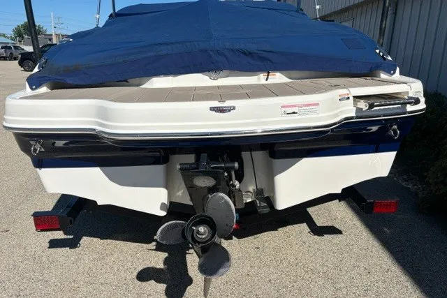 Slide: The Image of 2015 Chaparral 21 SSi Ski & Fish boat, rear view with covered deck and propeller. - 30
