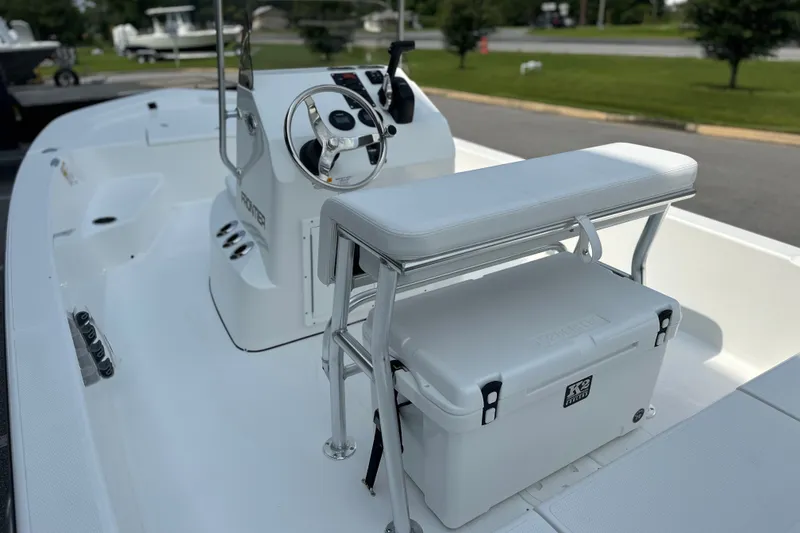Slide: The Image of 2027 Frontier 180 boat interior with steering console and cushioned seating. - 13