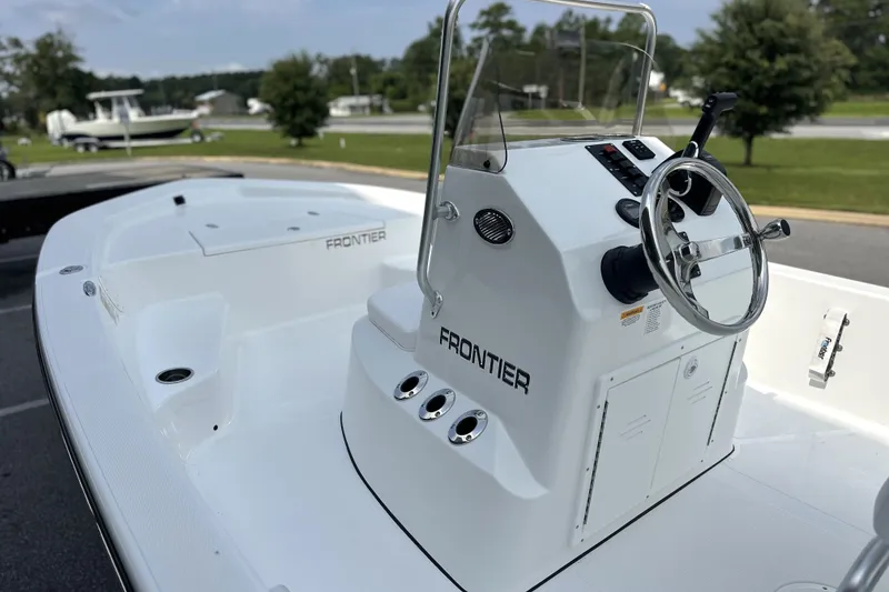 Slide: The Image of 2027 Frontier 180 boat with sleek white design and modern steering console. - 12
