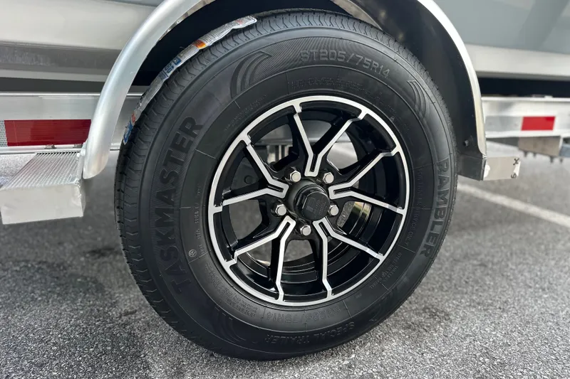Slide: The Image of Close-up of a Frontier 180 trailer wheel, featuring a black alloy rim and Taskmaster tire. - 8