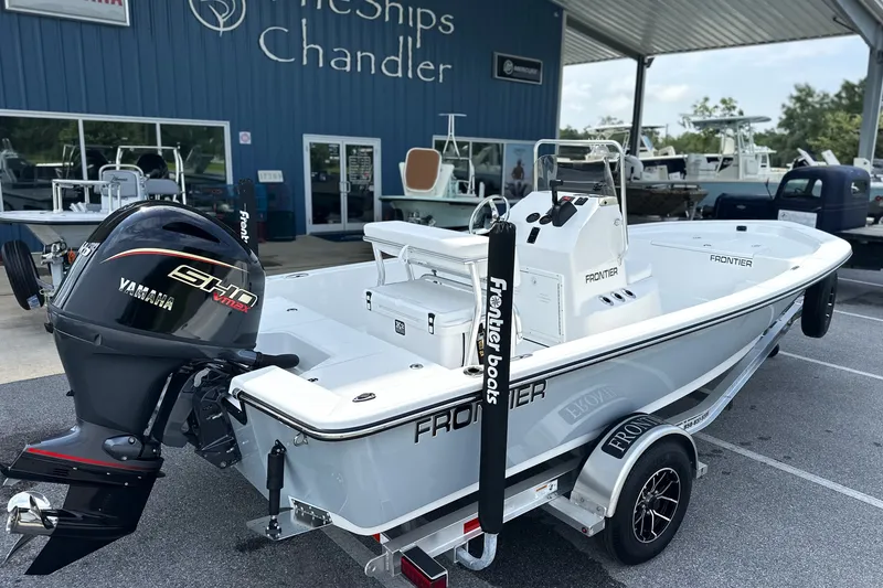 Slide: The Image of 2027 Frontier 180 boat with Yamaha engine at dealership, displayed on a trailer. - 3