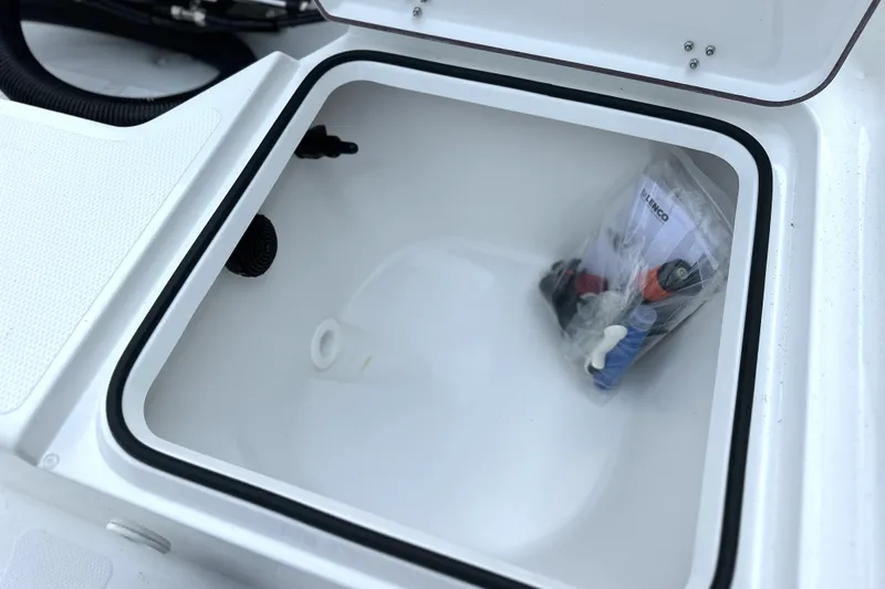 Slide: The Image of Open storage compartment on a 2027 Frontier 180 boat with accessories inside. - 6