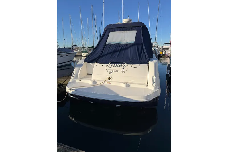 Slide: The Image of 2007 Sea Ray 340 boat docked at marina, rear view with blue cover. - 2