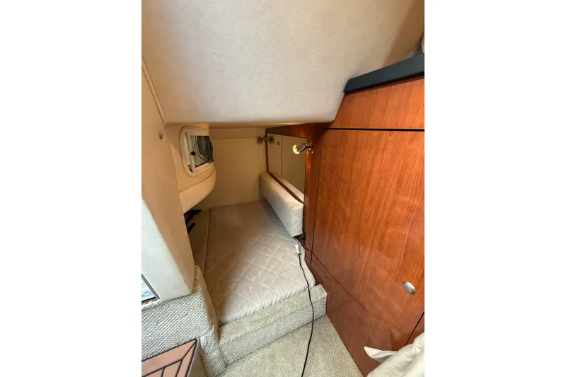 Slide: The Image of 2007 Sea Ray 340 cabin interior with wood paneling and cozy sleeping area. - 19