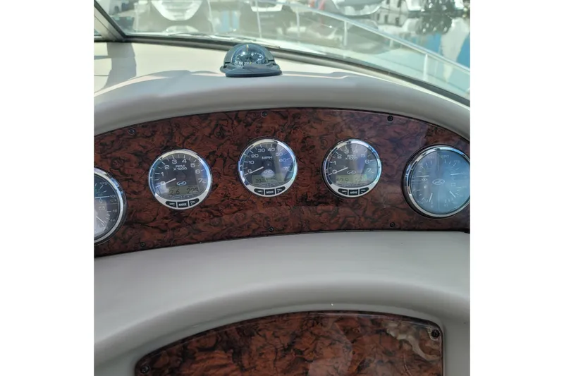 Slide: The Image of Dashboard of a 2007 Sea Ray 340 boat with wood paneling and gauges. - 23