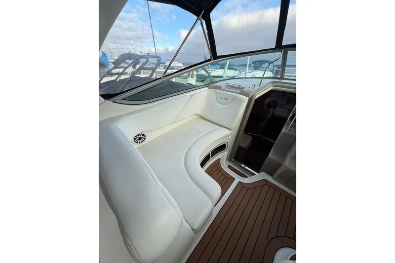 Slide: The Image of Interior of a 2007 Sea Ray 340 boat with white seating and wood flooring. - 16