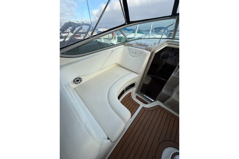 Slide: The Image of 2007 Sea Ray 340 boat interior with white seating and wood flooring. - 17