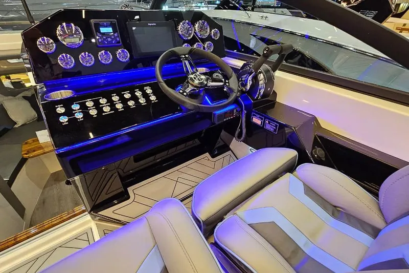 Slide: The Image of Luxurious 2026 Hanover 327 boat cockpit with modern controls and plush seating. - 19