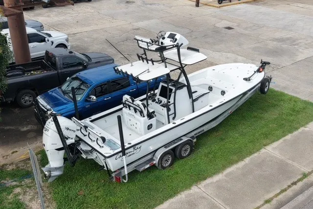 Slide: The Image of 2023 Canyon Bay 28h boat on trailer, parked beside a blue truck. - 4