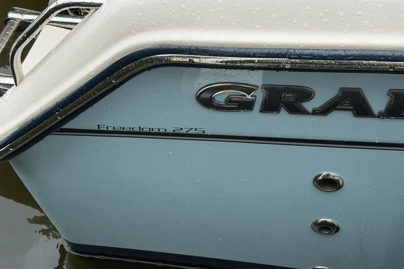 Slide: The Image of 2025 Grady-White Freedom 275 boat exterior with raindrops on the surface. - 11