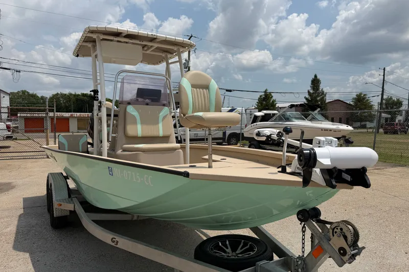 Slide: The Image of 2021 G3 Bay 20 DLX boat on trailer, parked outdoors under cloudy sky. - 6