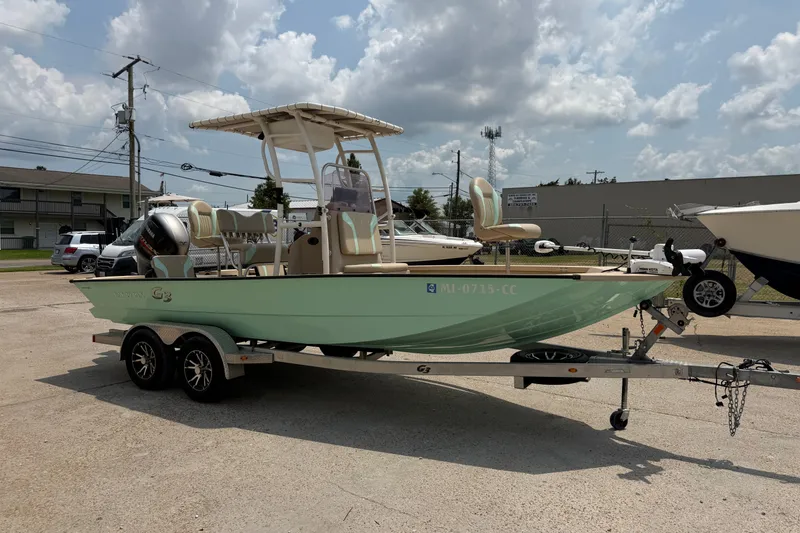 Slide: The Image of 2021 G3 Bay 20 DLX boat on trailer, parked outdoors under cloudy sky. - 5