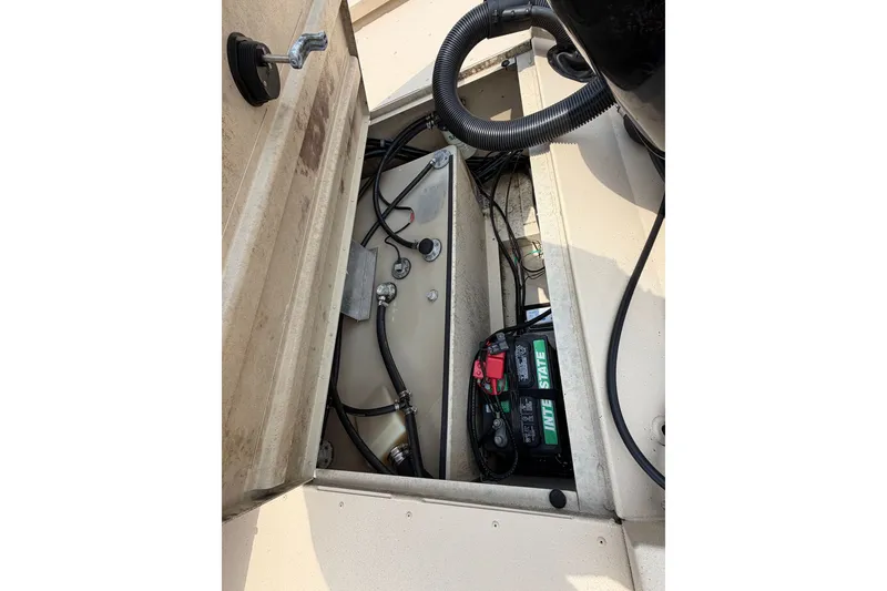 Slide: The Image of 2021 G3 Bay 20 DLX boat interior showing battery and wiring components. - 11